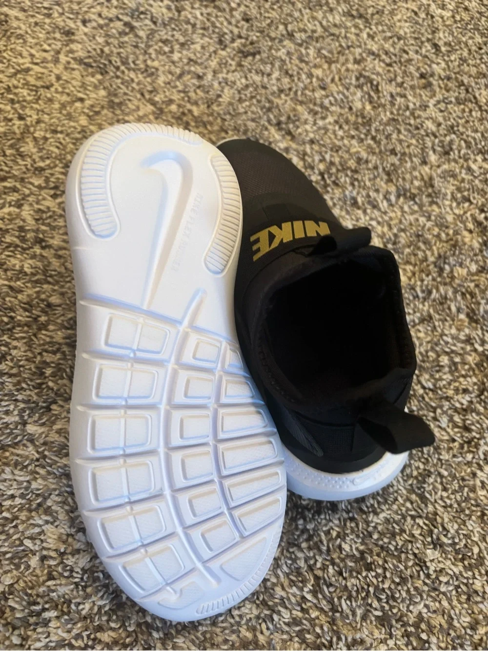 Nike Kids Black Slip-On Sneakers with Gold Logo Strap